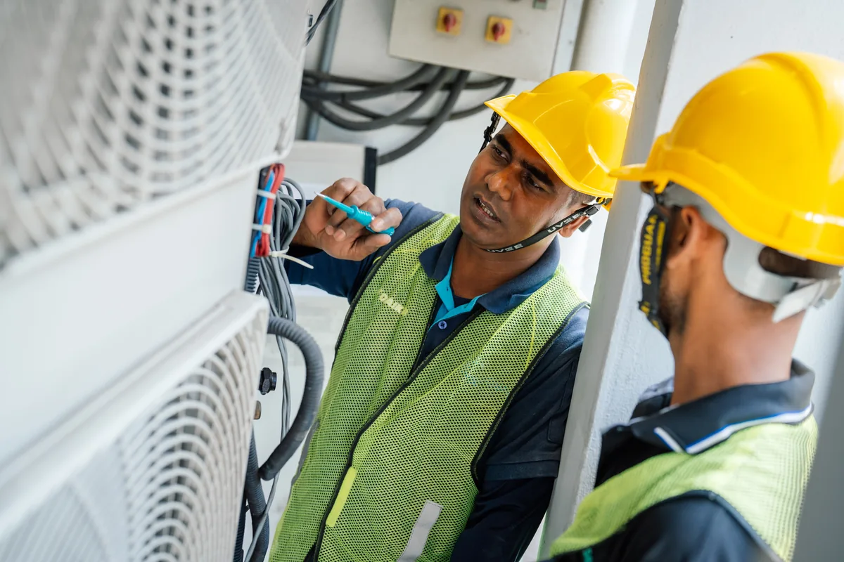 A VRF outdoor unit, its wiring being checked.